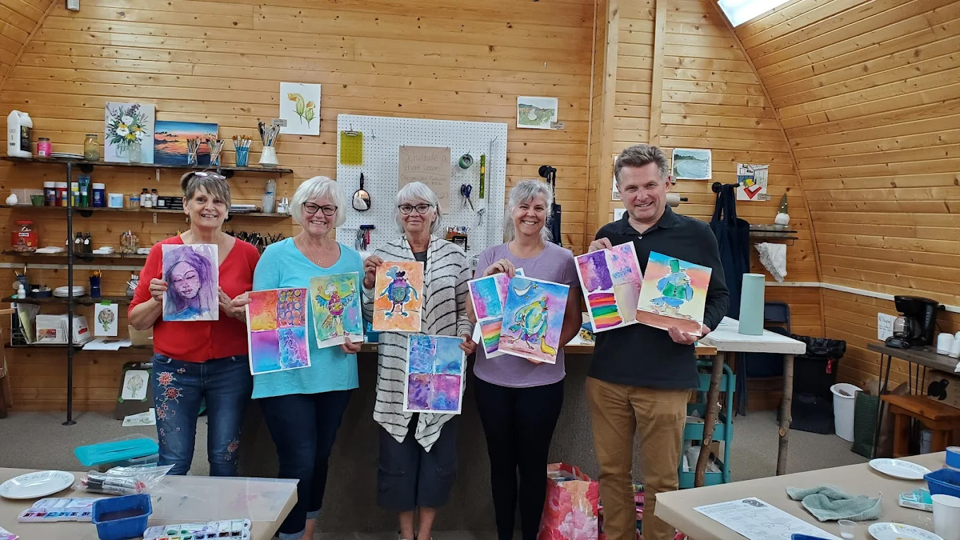 Students showing off their work at the Gladje gallery classroom